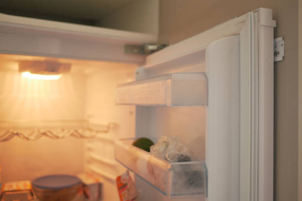 istock half open fridge with food and vegetables , 1830887757