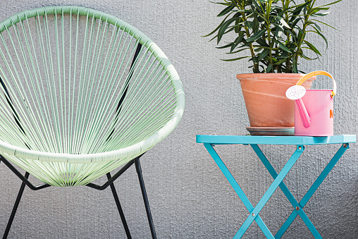 Watering can on a terrace in summer