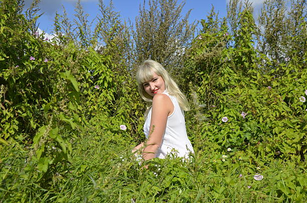 Beautiful woman portrait in flowers field