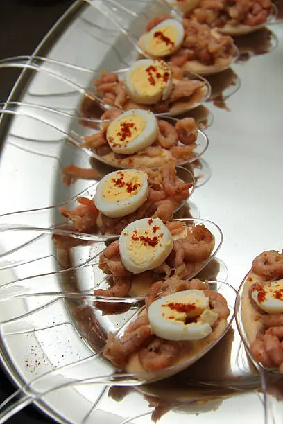 Shrimps in a dressing served on an amuse spoon