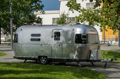 Berlin, Germany, 8/12/2023, Camper trailer with rounded and polished aluminum coachwork