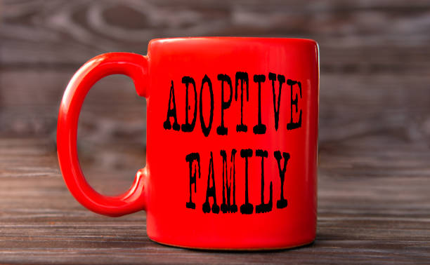 istock ADOPTIVE FAMILY - word on a red cup on a dark background. 1830940609