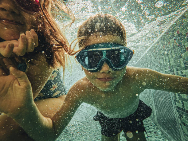 istock Kids swimming underwater 1830944805