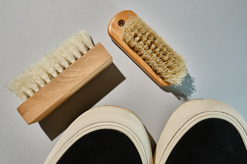 Shoe brushes and cleaning cloth close-up on a light background