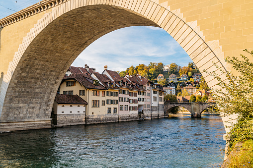 View of Bern old town and Aare river flowing under Untertorbrücke Bridge (Lower Gate Bridge) in Switzerland.