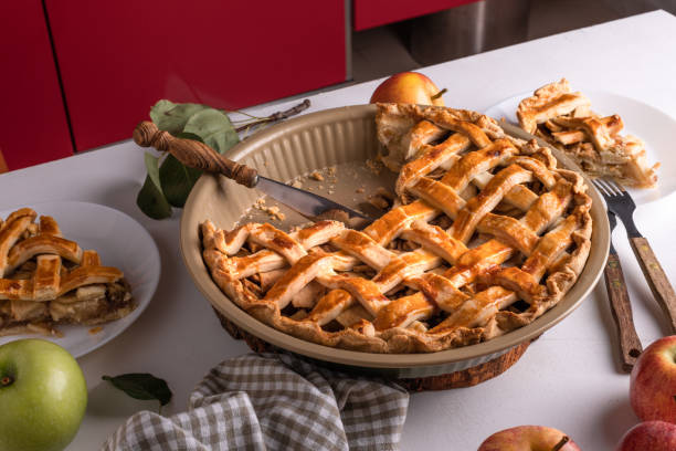 istock Homemade cutting Apple Pie with fresh apples on white kitchen table, ready to eat 1830967637