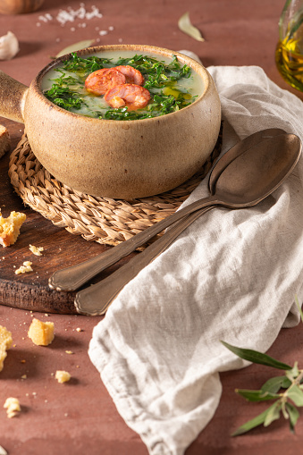 Caldo verde popular soup in Portuguese cuisine. Traditional ingredients for caldo verde are potatoes, onion, garlic, collard greens, chorizo , olive oil and salt. Is a comfort soup and is typically served with cornbread