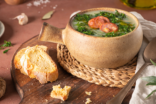 Caldo verde popular soup in Portuguese cuisine. Traditional ingredients for caldo verde are potatoes, onion, garlic, collard greens, chorizo , olive oil and salt. Is a comfort soup and is typically served with cornbread