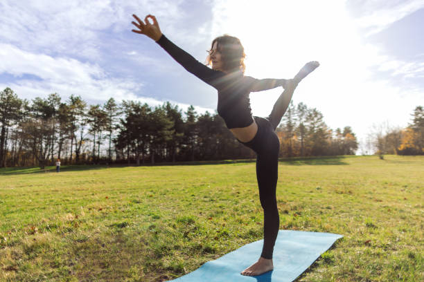istock Woman doing yoga in park 1831002557