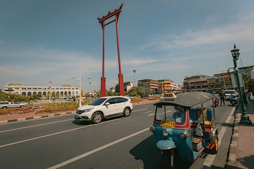 Giant Swink monument in the Bangkok city with tuk tuk next to it Thailand