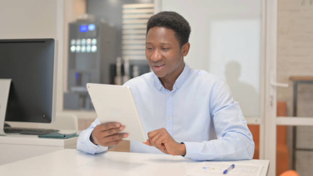 istock African Businessman Doing Video Chat on Tablet in Office 1831042081