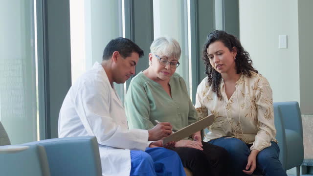 Patient listens as doctor explains recent medical test results