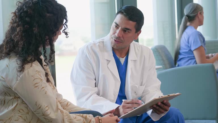 Doctor talks with female patient about her medical history