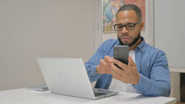 istock African Businessman Talking on Phone at Work 1831056016