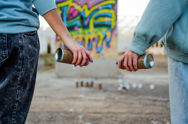istock Man and woman graffiti artists with spray cans 1831056036