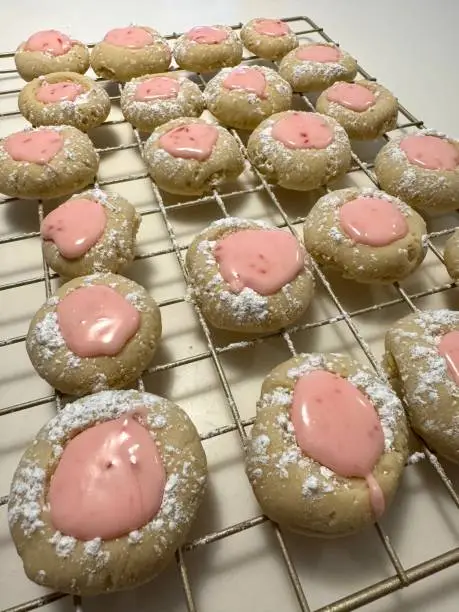Pink-lemonade thumbprint cookies on cooling rack