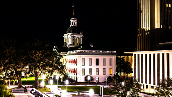 Tallahassee, FL cityscape at night: illuminated State Capitol rise above the buildings of Downtown Tallahassee in Florida. Photo denoise and enchanse
