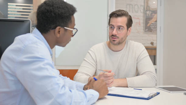 istock Displeased Business People having Argument at Work, Paperwork 1831079317
