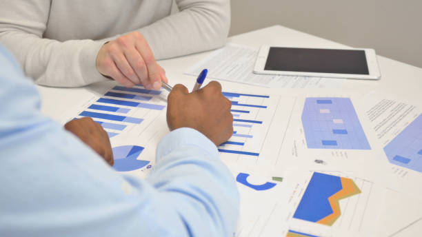 istock Close up of Business People Doing Paperwork in Office 1831079861