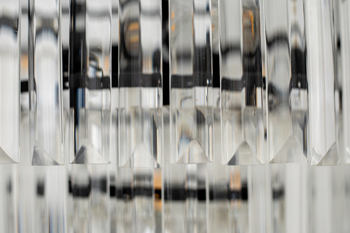 Close-up details of chandelier made of glass, crystal and black metal. Interior design. Lighting.