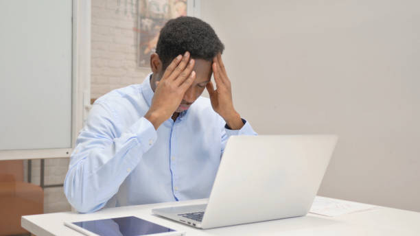 istock African Businessman having Headache at Work 1831091615