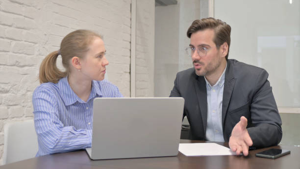 istock Businessman Talking with Female Partner in Meeting 1831091632