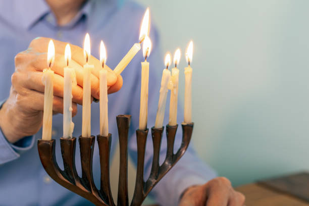 istock Man celebrates Hanukkah at home 1831099067
