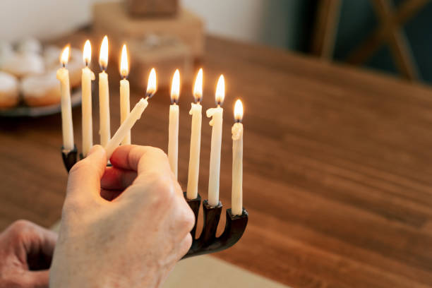 istock Man celebrates Hanukkah at home 1831099599