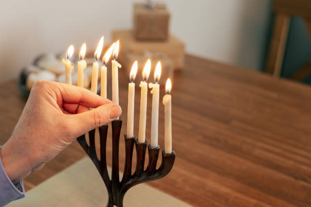 istock Man celebrates Hanukkah at home 1831099990