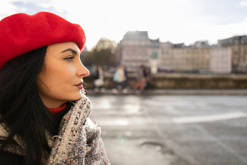 pretty woman with beret walking through the streets of Paris - tourist, traveler -