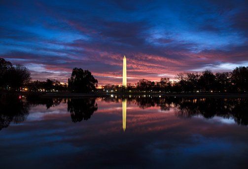 Washington Monument at night with dramatic clouds