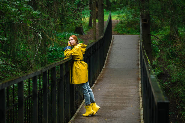 istock Woman in yellow raincoat 1831136387