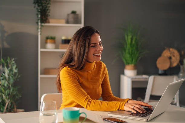 istock A happy freelancer is sitting at home office and using a laptop. 1831143712