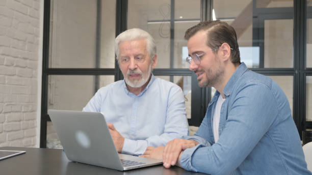 istock Online Chat by Business People on Laptop at Work 1831152698