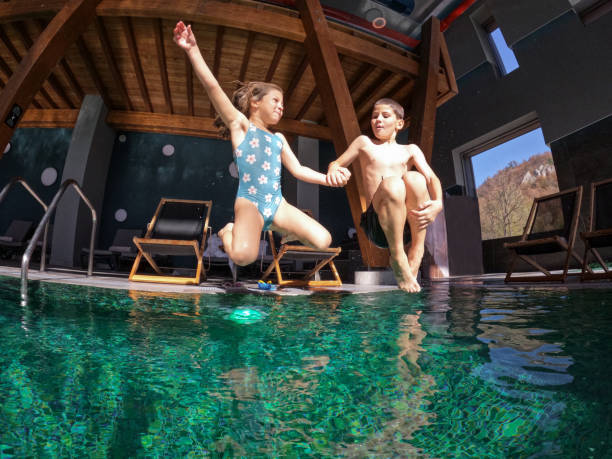 istock Kids jumping in the pool 1831160727