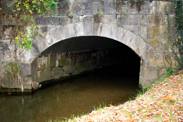 istock Creek running through a stone tunnel bridge 1831161698