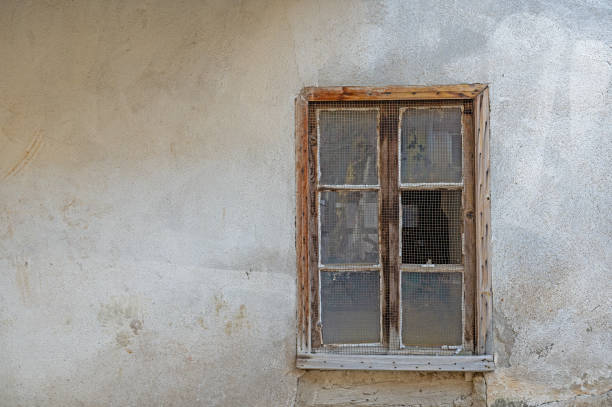 istock Wire in the window of an old house. 1831176137