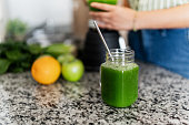 Close-up of a glass of detox juice in kitchen counter