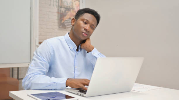 istock African Businessman having Neck Pain at Work 1831180386