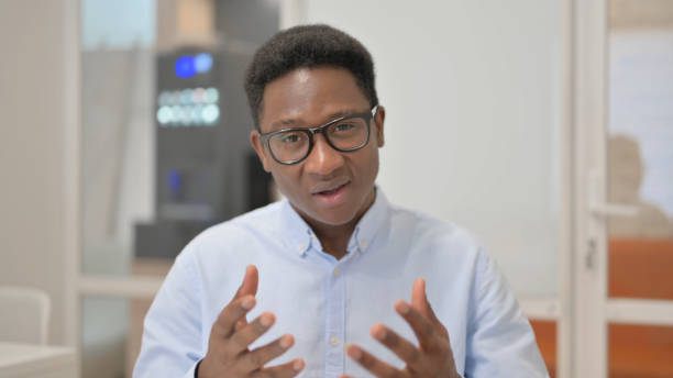 istock Blogging African Businessman Doing Video Chat in Office 1831186081