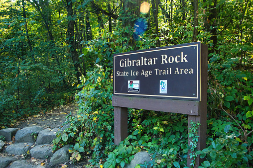 A wooden sign identifies the Gibraltar Rock Segment of The Ice Age Trail, as viewed on a Summer day near Lodi, Wisconsin.