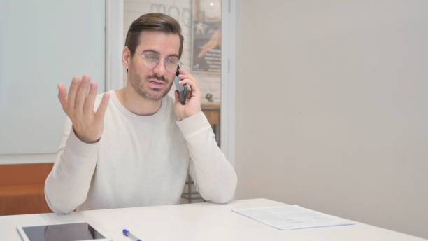 Middle Aged Man Talking on phone in Office Middle Aged Man Talking on phone in Office 32330 stock pictures, royalty-free photos & images