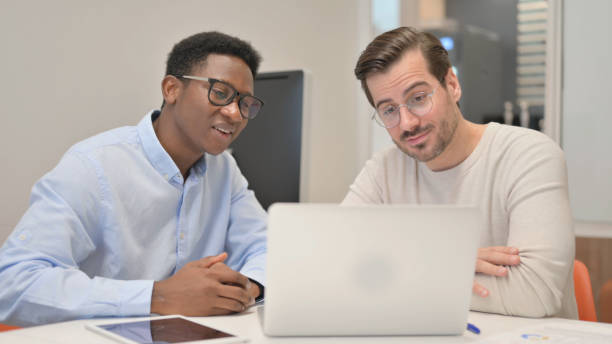 istock Online Chat by Business People on Laptop at Work 1831241686