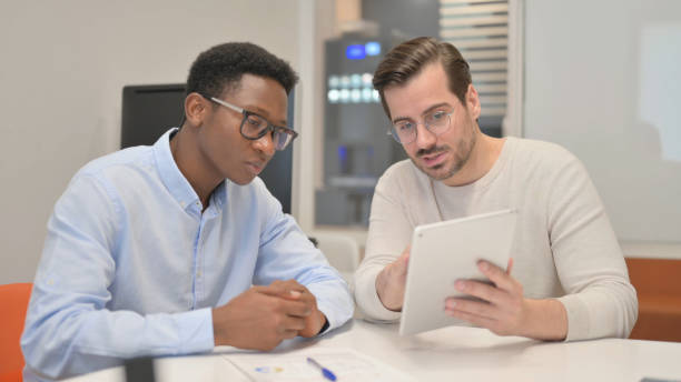 istock Business People Discussing Project on Digital Tablet 1831244279