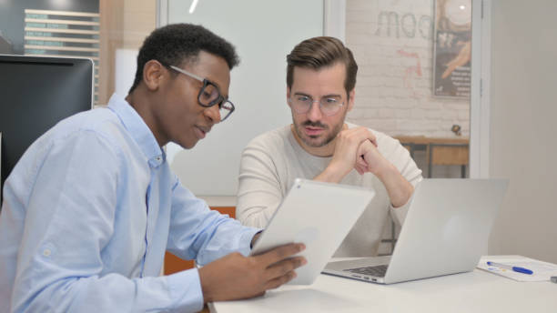 istock African Businessman Discussing Work with Business Partner 1831248895