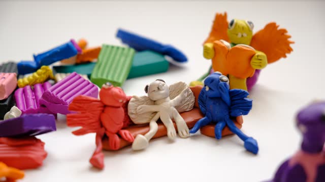 Child making colorful plasticine dragons family and creating.  Fairy tale card with cartoon animals.