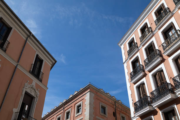 Pink buildings with balconies in downtown Madrid , Spain