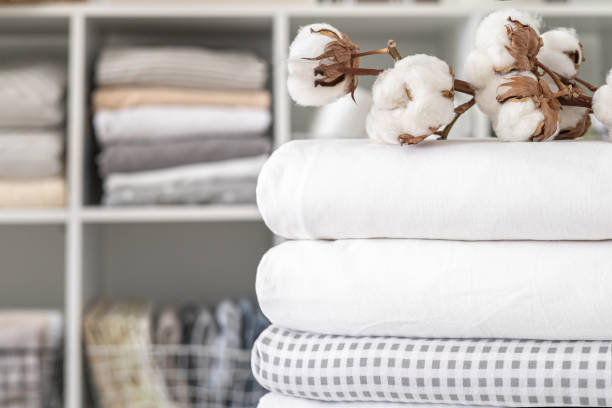 istock Cotton branch with pile of folded bed sheets and blankets 1831261966