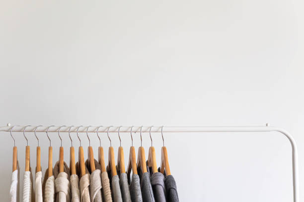 istock Hanger with neutral beige and white clothes on a white background. 1831273536