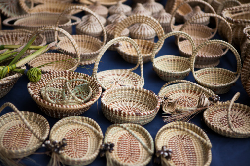 An assortment of sweetgrass baskets arranged for sale at a Charleston market.